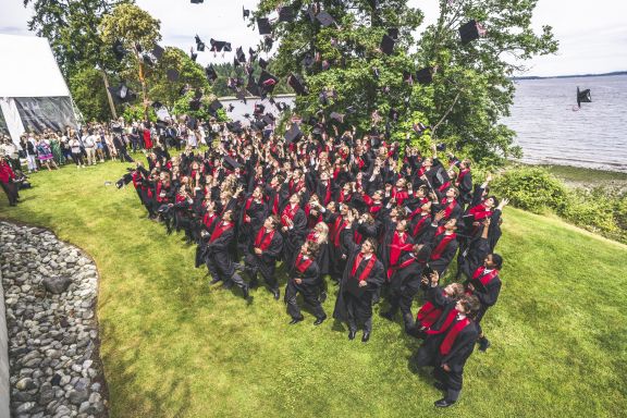 The grad caps being tossed in the air at the graduation ceremony