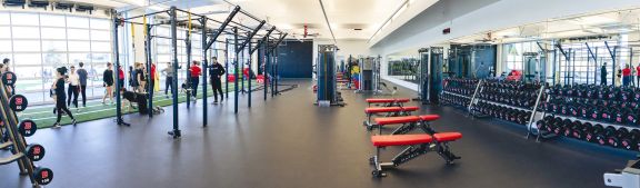 A wide view of the entire gym with weights and machines