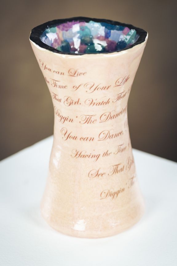 A tall and narrow vase of pottery